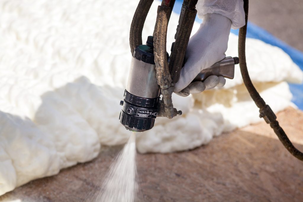 spray foam insulation contractors actively spraying foam insulation